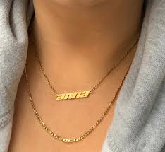 The Elegance of a 2.5mm Gold Figaro Necklace on Neck