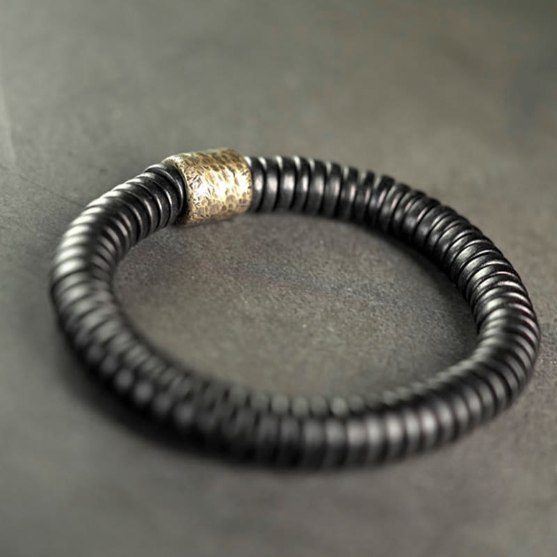 Bracelet calme en bois d'ébène et cuivre et laiton avec pierres de Bouddha