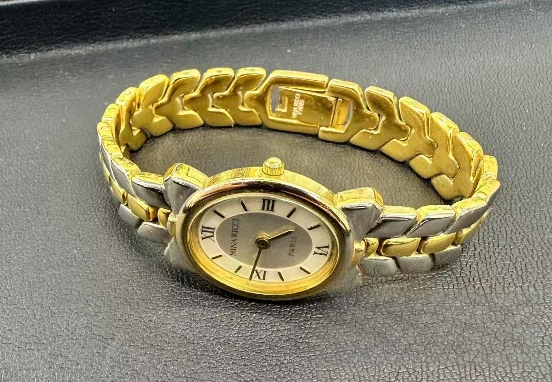 Montre vintage Nina Ricci Swiss Bow bicolore