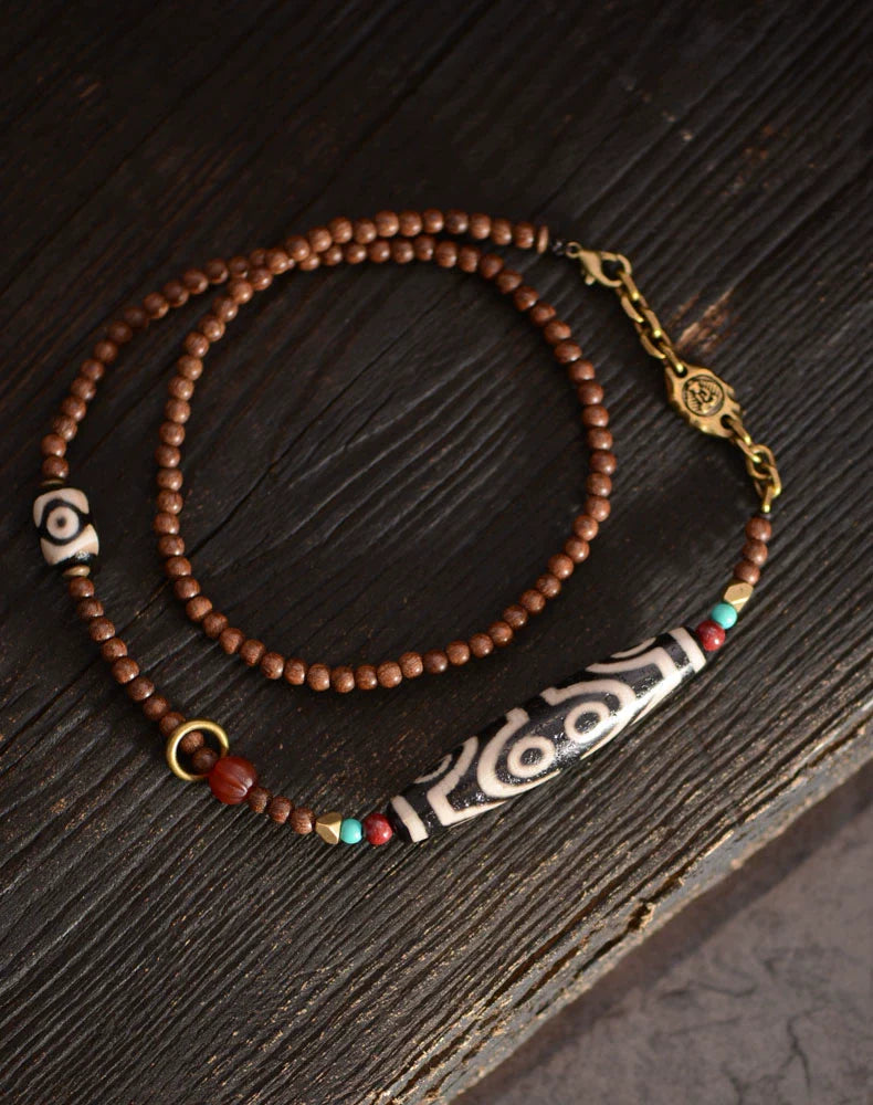 Pendentif perles dzi tibétaines en bois de santal doré 58 mm