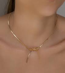 The Heartfelt Charm of the Gold Bow Necklace