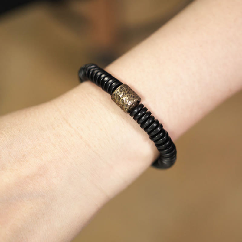 Bracelet calme en bois d'ébène et cuivre et laiton avec pierres de Bouddha 