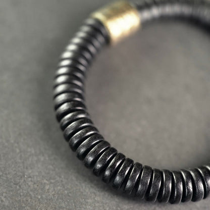 Bracelet calme en bois d'ébène et cuivre et laiton avec pierres de Bouddha 