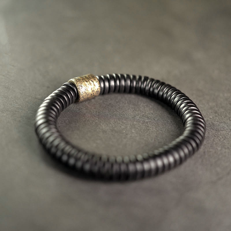 Bracelet calme en bois d'ébène et cuivre et laiton avec pierres de Bouddha 