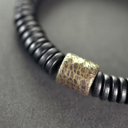 Bracelet calme en bois d'ébène et cuivre et laiton avec pierres de Bouddha 
