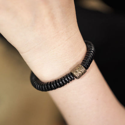 Bracelet calme en bois d'ébène et cuivre et laiton avec pierres de Bouddha 