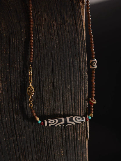 Pendentif perles dzi tibétaines en bois de santal doré 58 mm