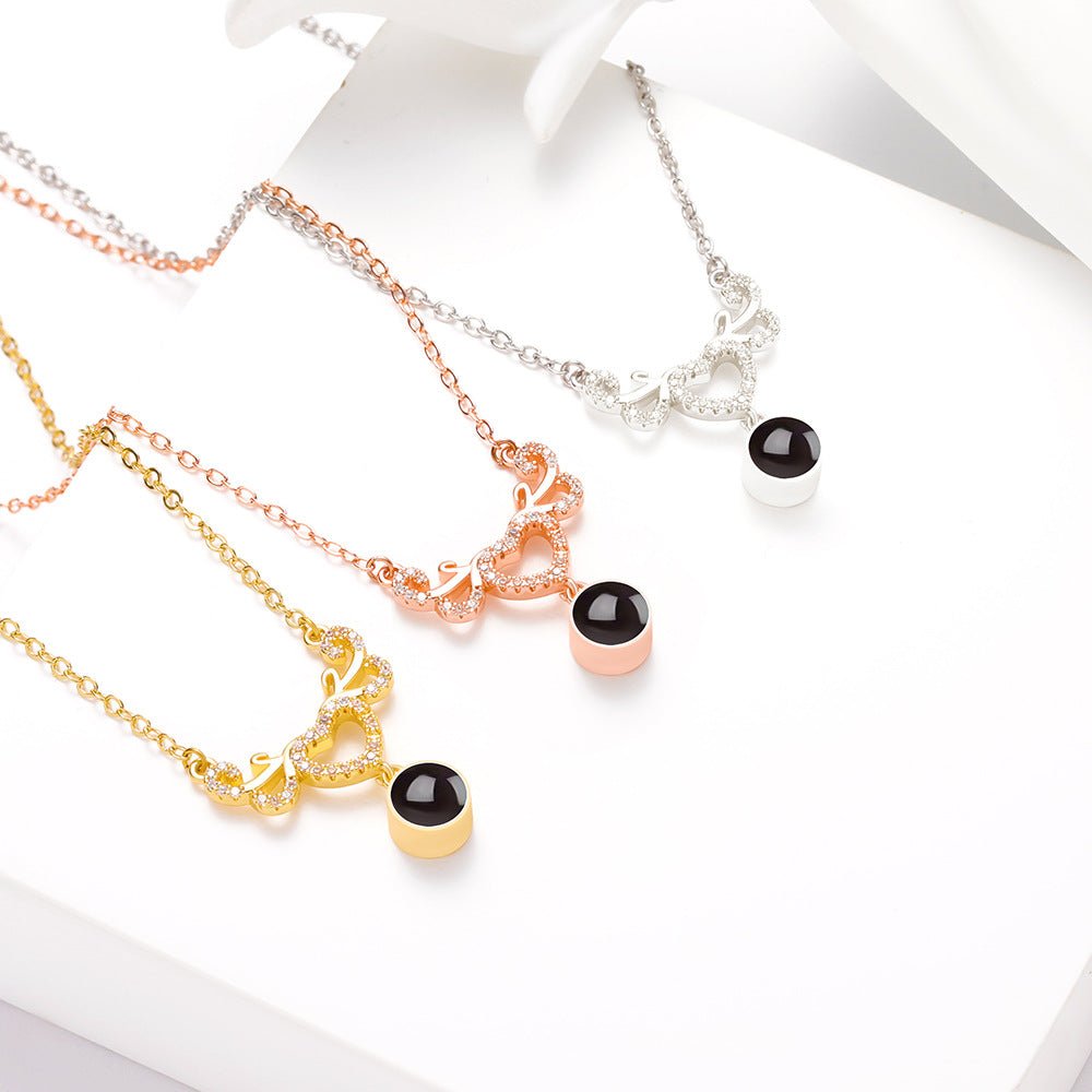 Collier personnalisé avec projection photo cachée en forme de cœur ailé